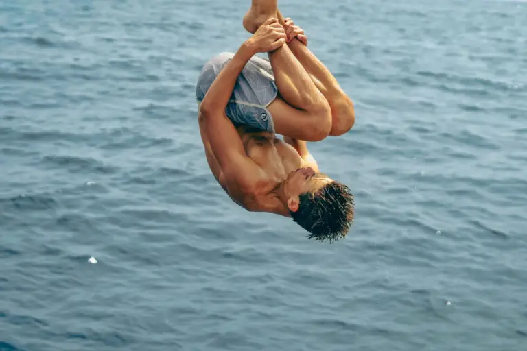 A guest throws a backflip off the boat into the open water off the Nosara coast.
