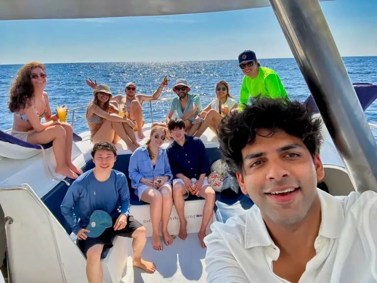 A guide takes a selfie with guests seated along the catamaran's shaded deck off Nosara.