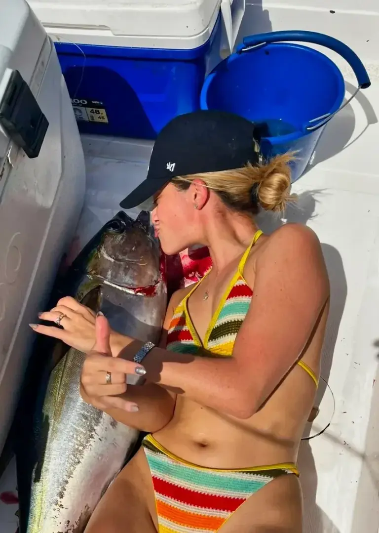 A guest holds a freshly landed mahi-mahi on the boat deck off the Guanacaste coast.