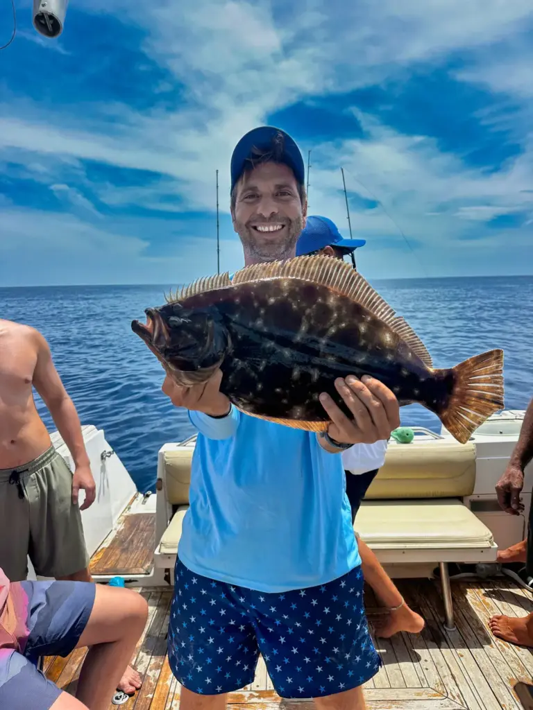 A crew member shows a flounder landed in the shallow water off the Nosara coast.